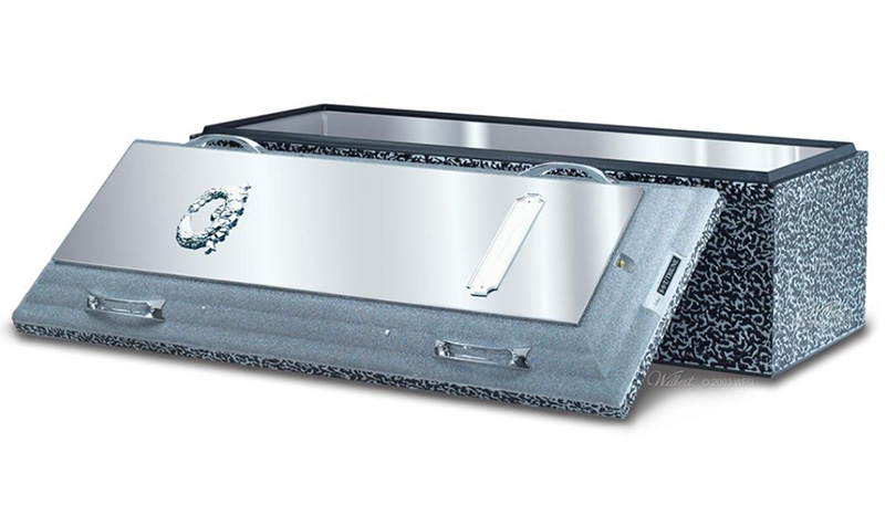 A metallic burial vault, a dignified piece of burial merchandise, features a partially open lid with decorative silver handles and a wreath design. The speckled gray and black exterior reveals the smooth interior.
