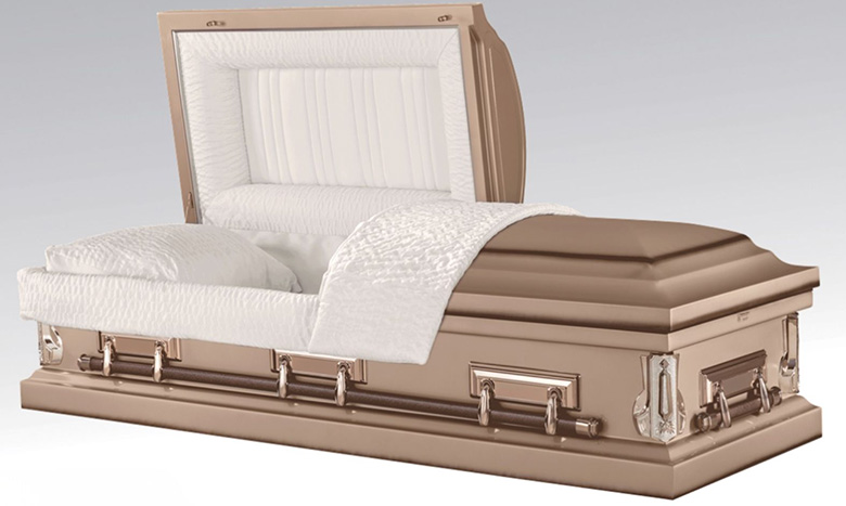 A bronze-colored burial merchandise casket with silver handles, partially open to reveal a white cushioned interior with a matching pillow and blanket.
