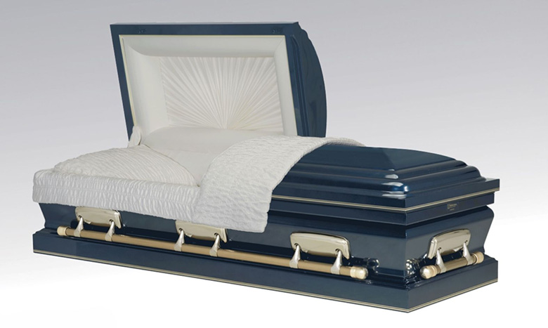 A dark blue and silver metal casket, part of refined burial merchandise, with the lid partially open to reveal a white cushioned interior and a neatly folded white blanket.