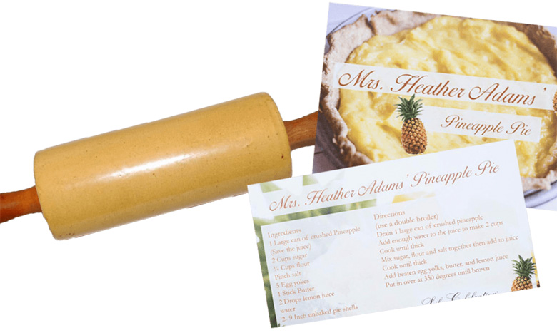 A rolling pin and two recipe cards for Ms. Heather Adams Pineapple Pie, perfect for life celebrations—one card displays a tempting pie, while the other lists all the ingredients and directions needed to create this festive treat.